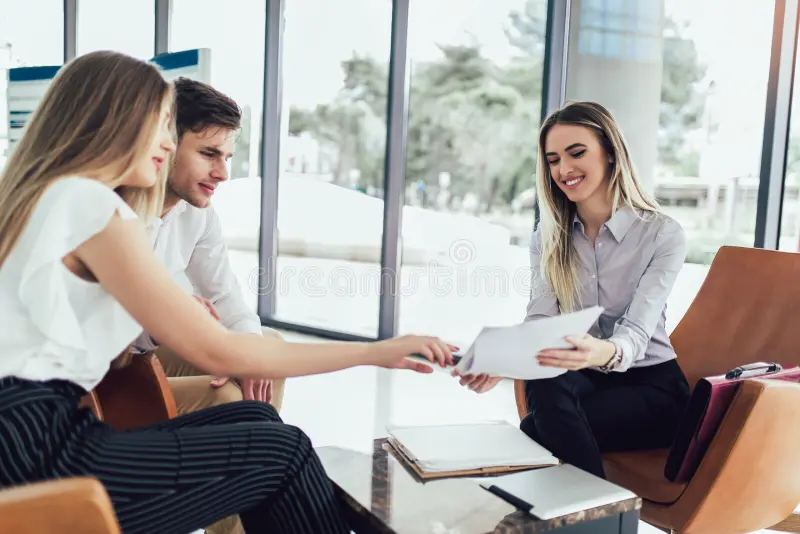 "Financial advisor reviewing Opportunity Down Payment Assistance options with a couple"